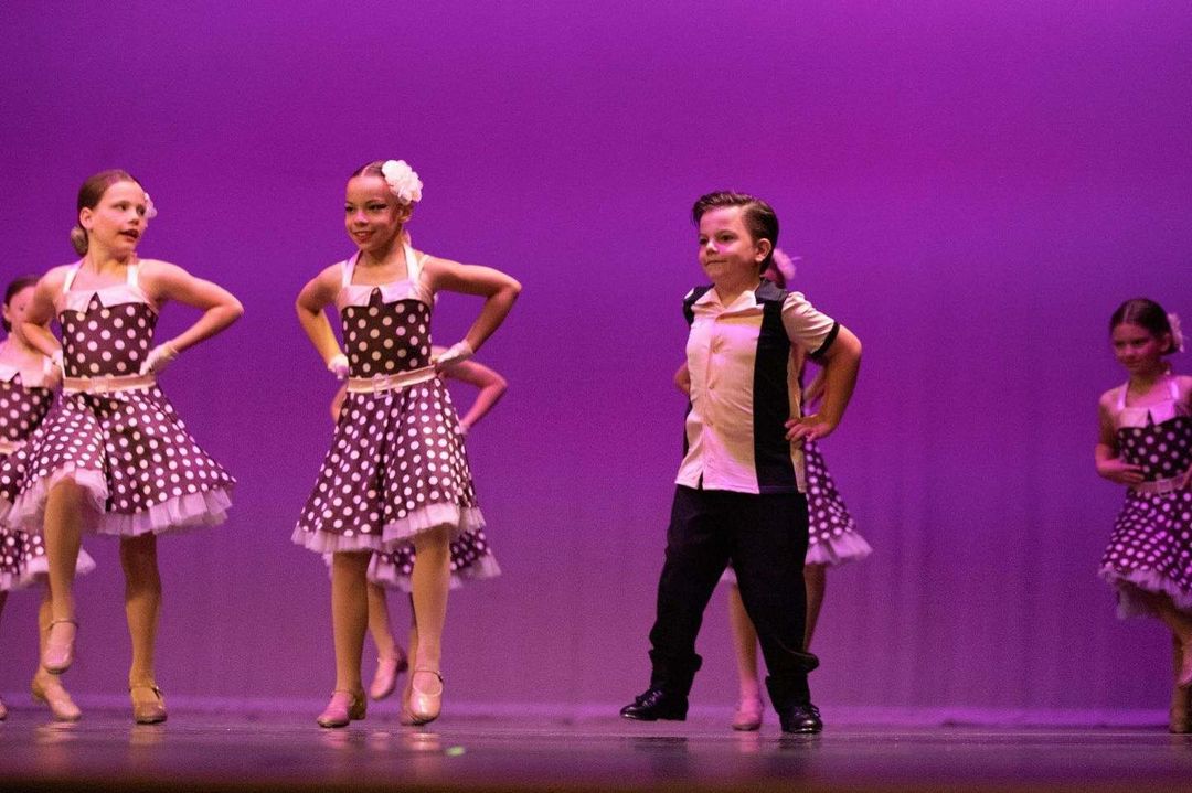 young girls and boy performing on stage
