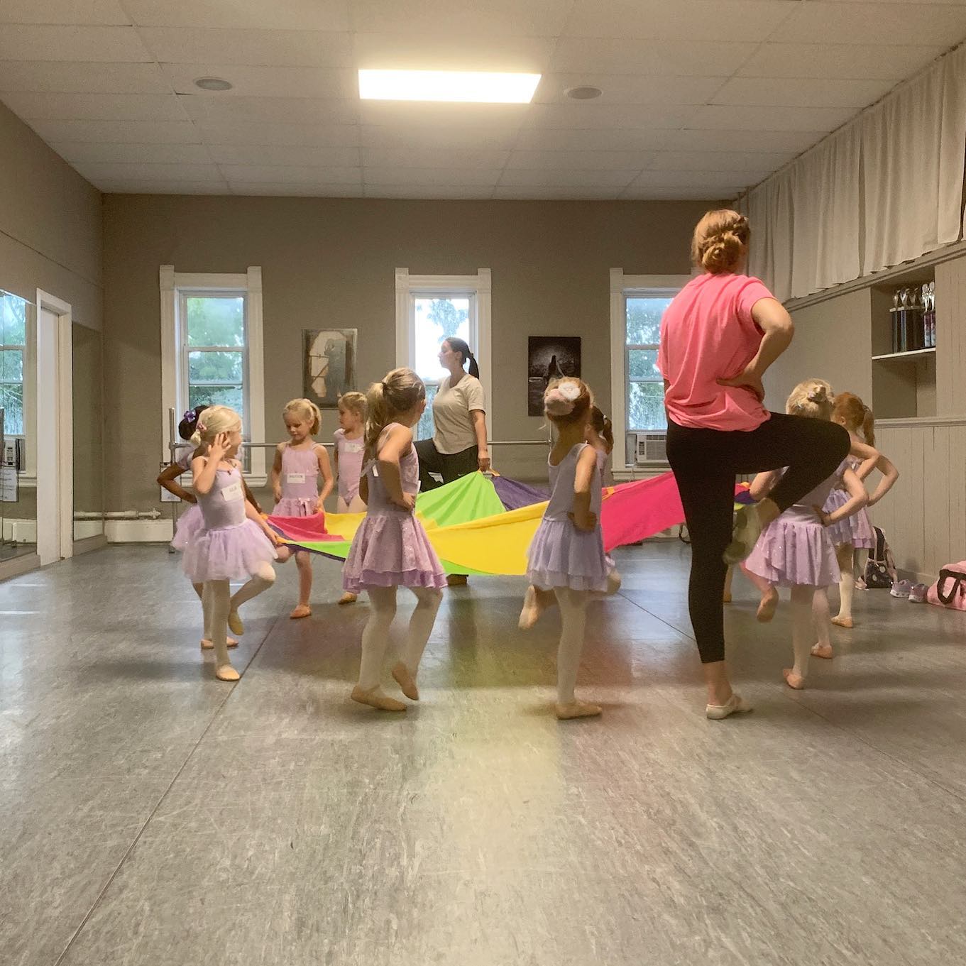 young dancers and teacher with parachute