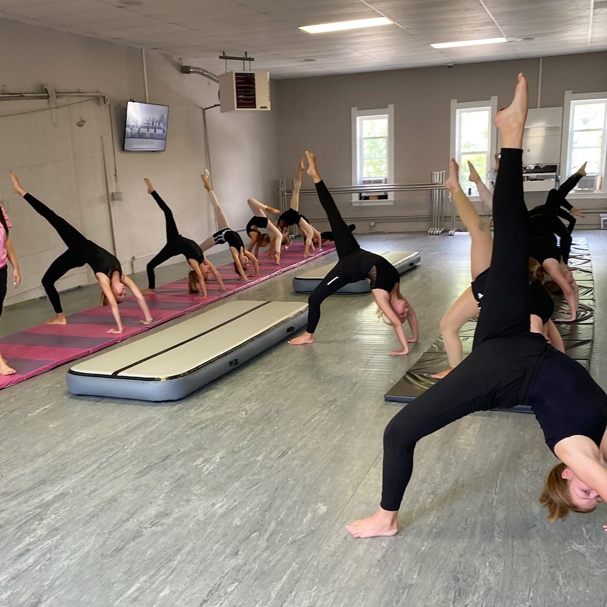 acro students in back bend stretch