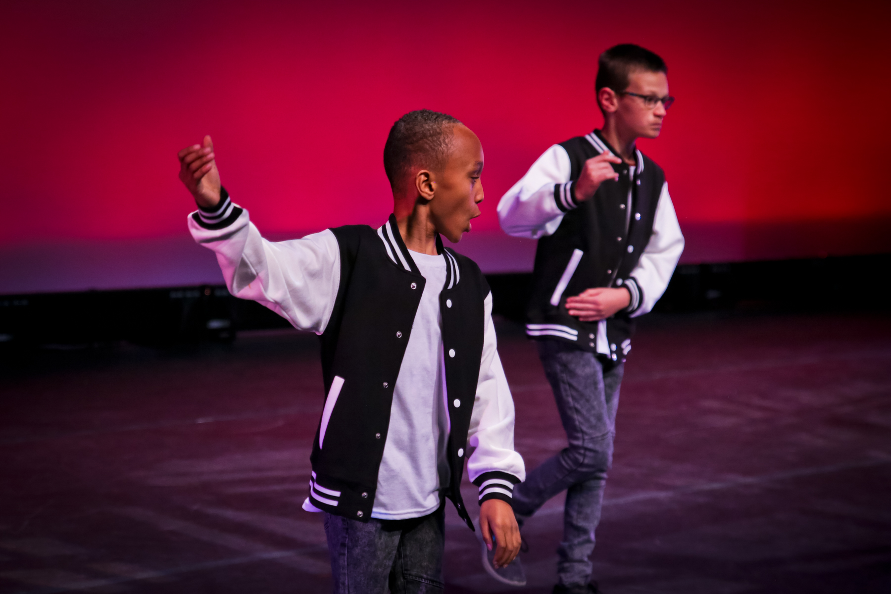 young girls and boy performing on stage