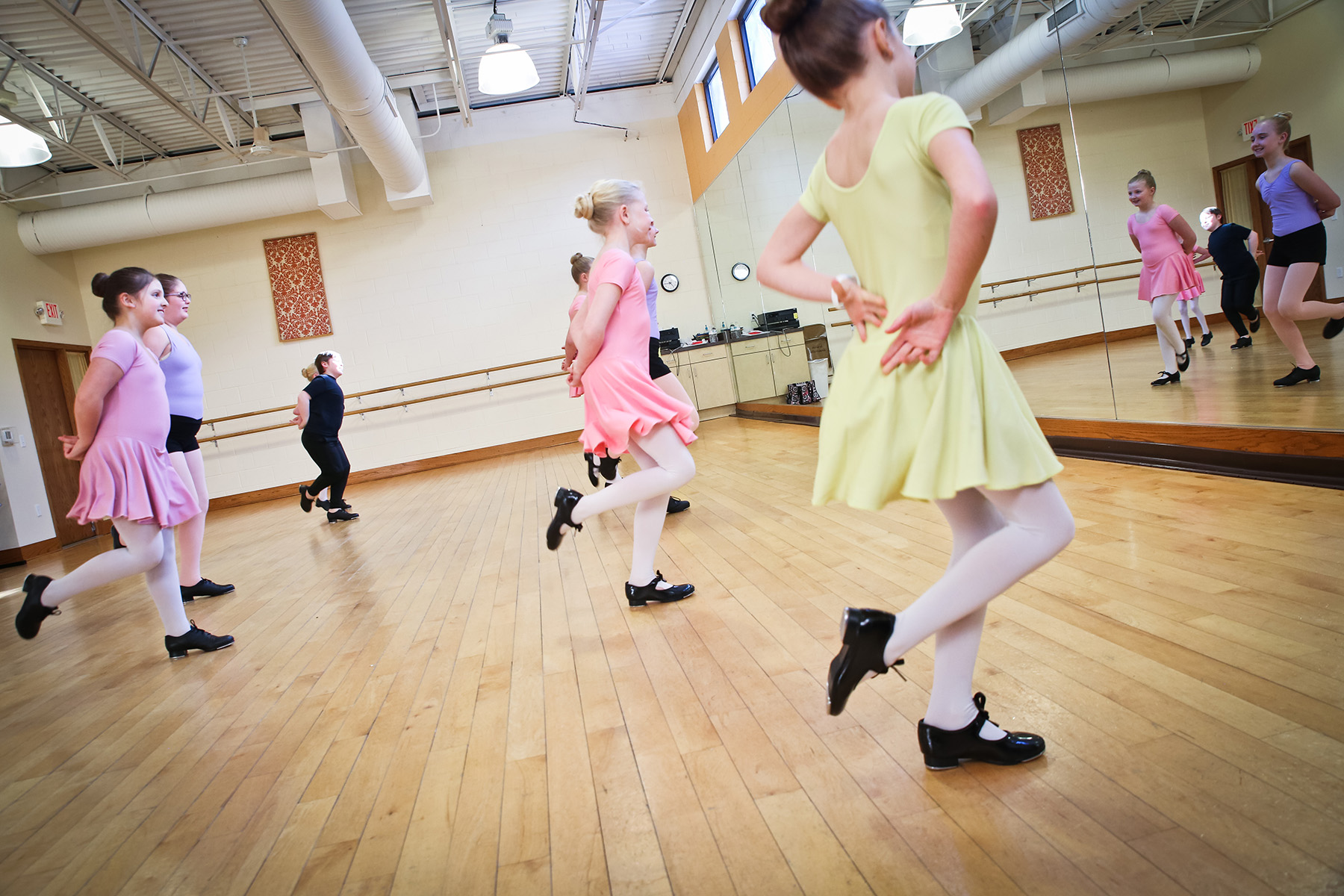 older dancer with younger dancer in studio